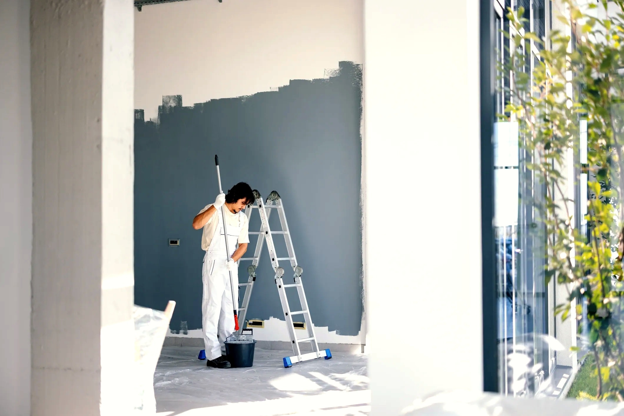 Professional painter working on interior wall